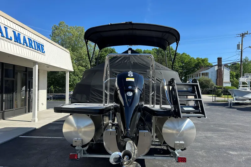 Slide: The Image of 2026 Harris Cruiser 230 CWDH pontoon boat at a marina, rear view. - 24