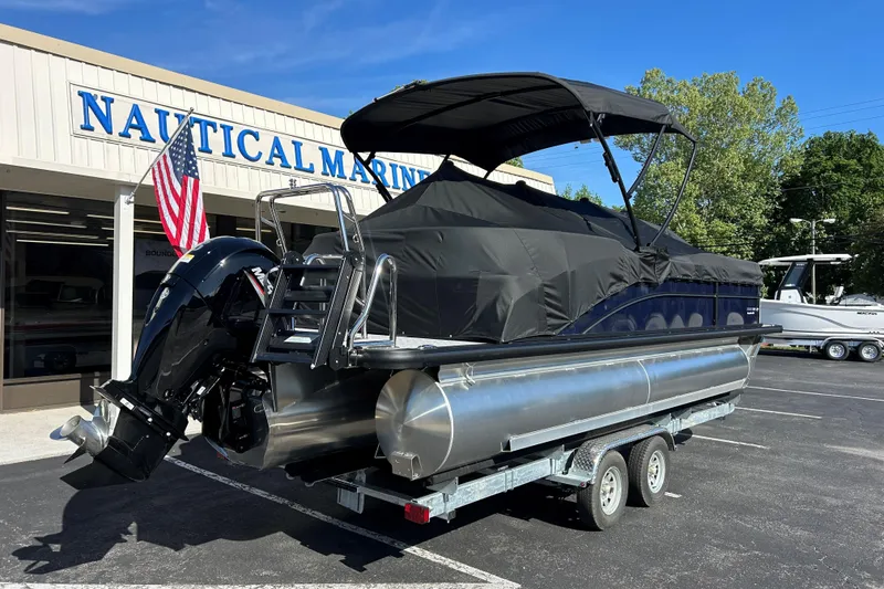 Slide: The Image of 2026 Harris Cruiser 230 CWDH pontoon boat on trailer at Nautical Marine dealership. - 25