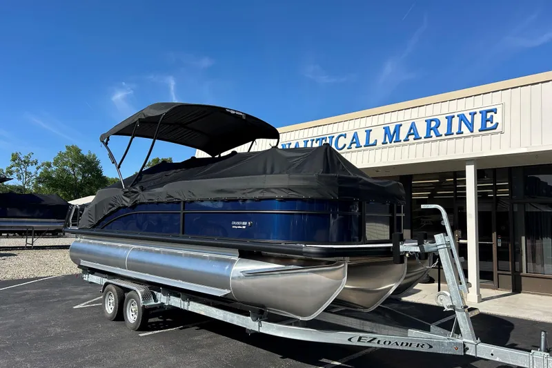 Slide: The Image of 2026 Harris Cruiser 230 CWDH pontoon boat on trailer outside Nautical Marine. - 26