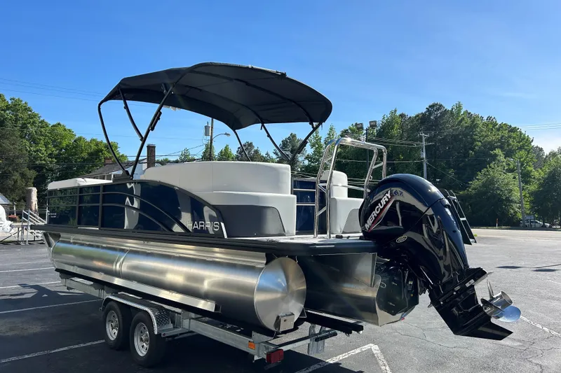 Slide: The Image of 2026 Harris Cruiser 230 CWDH pontoon boat on trailer, featuring Mercury outboard motor. - 4