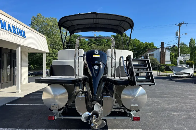 Slide: The Image of 2026 Harris Cruiser 230 CWDH pontoon boat displayed at a marine dealership. - 5