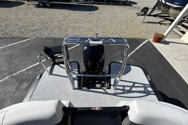 Slide: The Image of 2026 Harris Cruiser 230 CWDH pontoon boat with sleek design and modern outboard motor. - 7