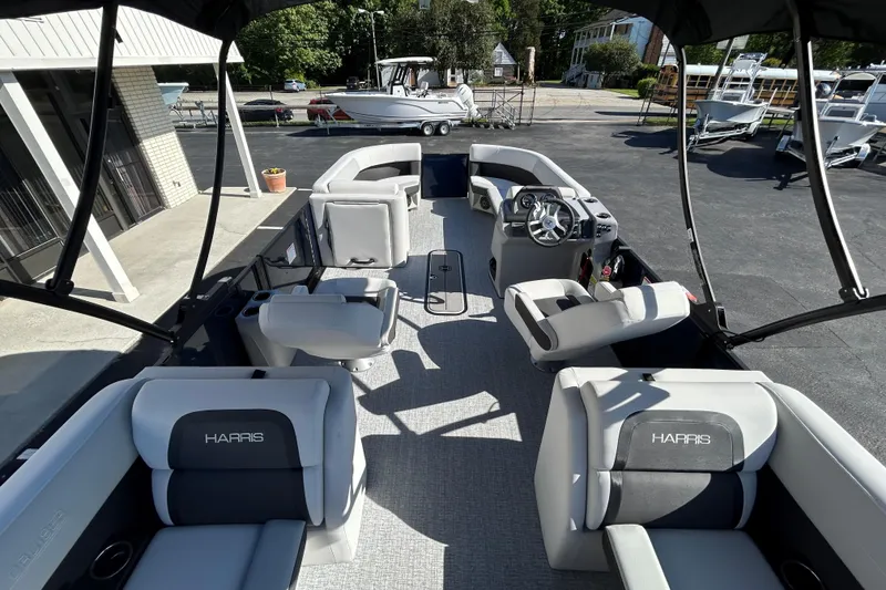 Slide: The Image of 2026 Harris Cruiser 230 CWDH pontoon boat interior with plush seating and modern helm. - 8