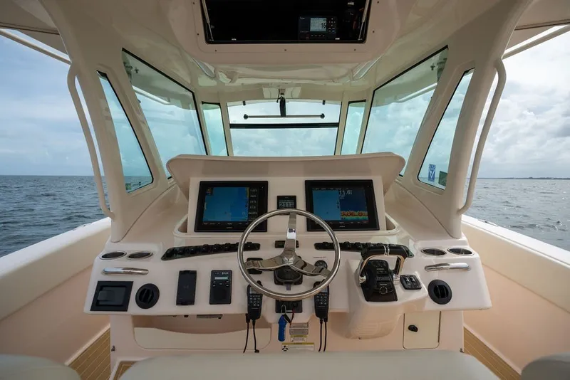 Slide: The Image of Helm of 2014 Grady-White Canyon 376 boat with navigation screens and steering wheel. - 36