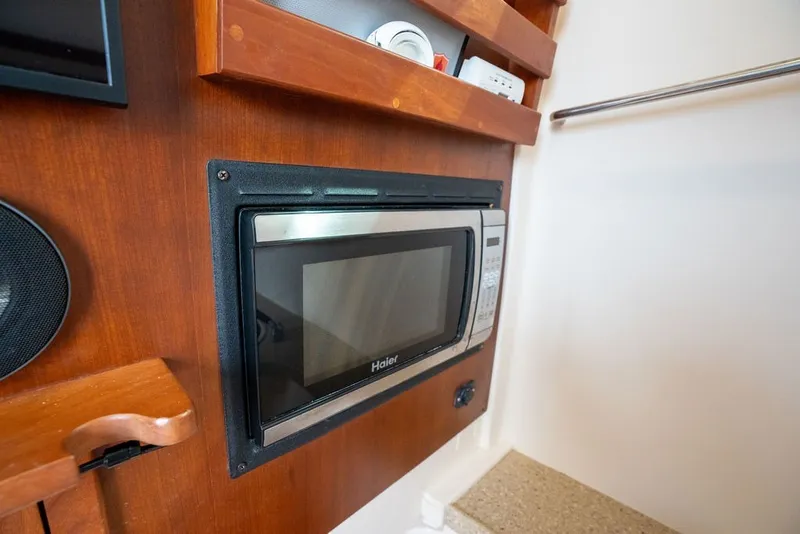 Slide: The Image of Built-in microwave in 2014 Grady-White Canyon 376 boat interior. - 60