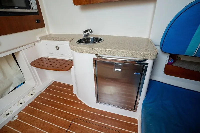 Slide: The Image of 2014 Grady-White Canyon 376 boat interior with sink, countertop, and mini fridge. - 63