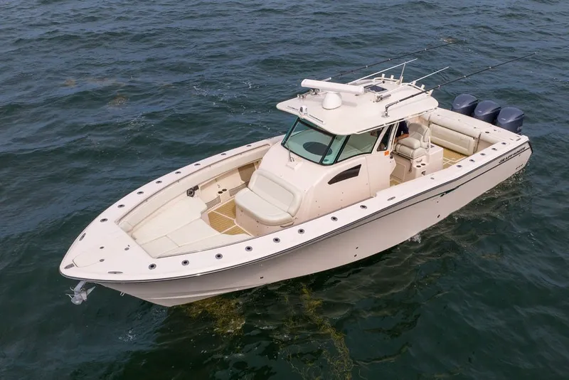 Slide: The Image of 2014 Grady-White Canyon 376 boat on open water, featuring triple outboard engines. - 3