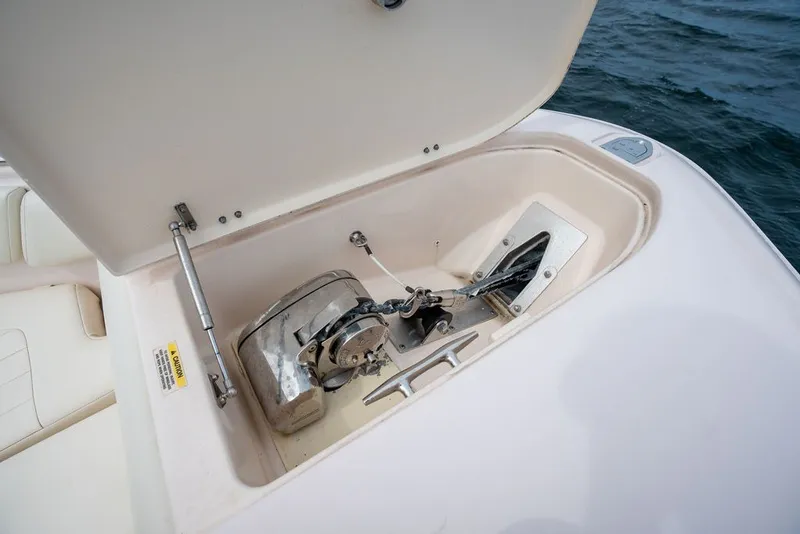 Slide: The Image of Anchor compartment of 2014 Grady-White Canyon 376 boat, open lid, ocean background. - 20