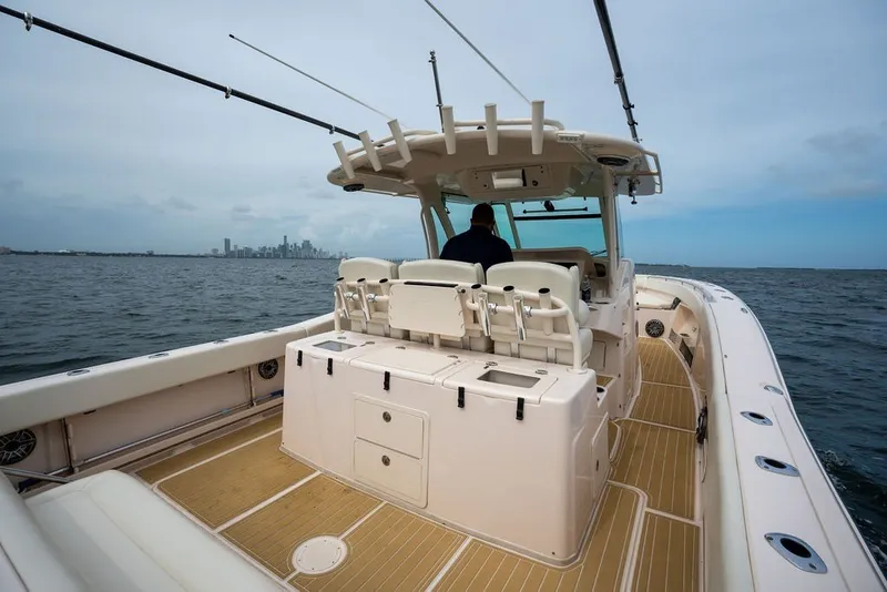 Slide: The Image of 2014 Grady-White Canyon 376 boat on open water with city skyline in background. - 29