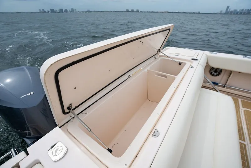 Slide: The Image of Open storage compartment on 2014 Grady-White Canyon 376 boat, ocean backdrop. - 27