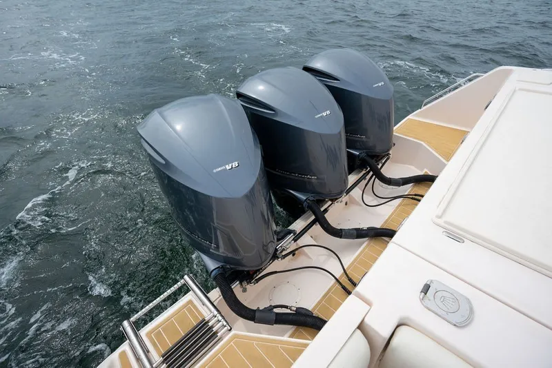 Slide: The Image of Triple Yamaha V8 engines on a 2014 Grady-White Canyon 376 boat in water. - 28