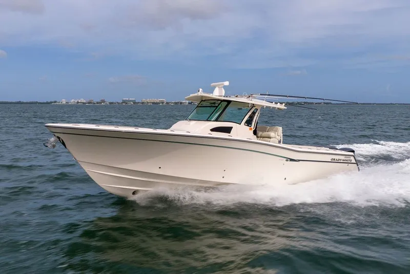 Slide: The Image of 2014 Grady-White Canyon 376 boat cruising on open water under clear skies. - 9