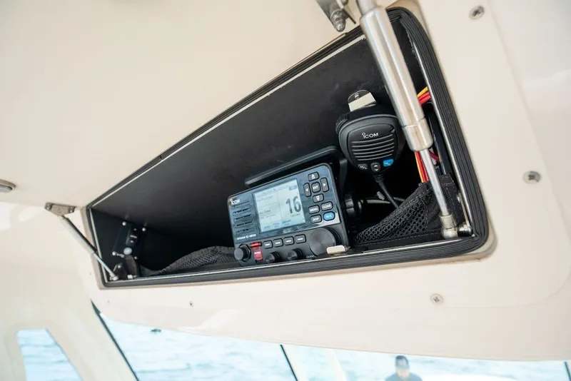 Slide: The Image of 2014 Grady-White Canyon 376 boat radio compartment with Icom communication equipment. - 44