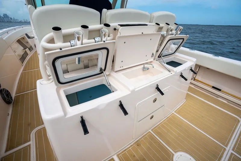 Slide: The Image of 2014 Grady-White Canyon 376 boat interior with fishing rod holders and storage compartments. - 31