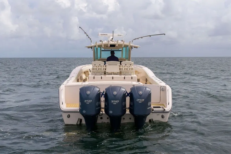 Slide: The Image of 2014 Grady-White Canyon 376 boat with triple Yamaha 350 engines on open water. - 6