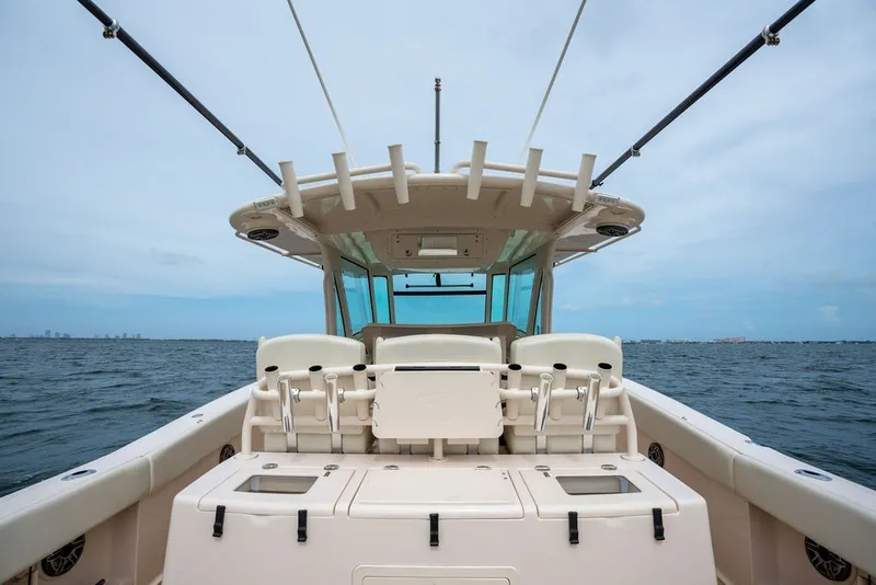 Slide: The Image of 2014 Grady-White Canyon 376 boat on open water, showcasing helm and seating area. - 35