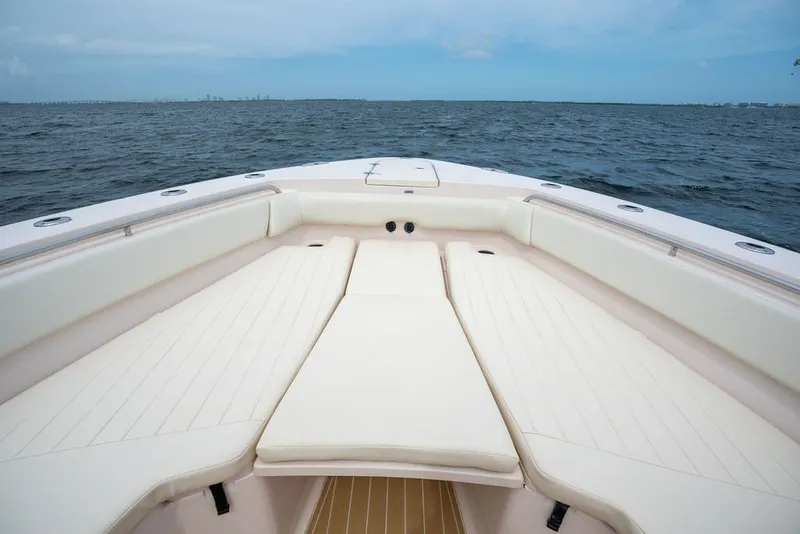 Slide: The Image of 2014 Grady-White Canyon 376 boat interior with cushioned seating, ocean view. - 17