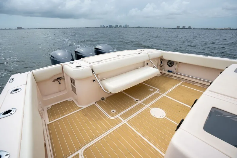 Slide: The Image of 2014 Grady-White Canyon 376 boat deck with seating, overlooking calm waters. - 23