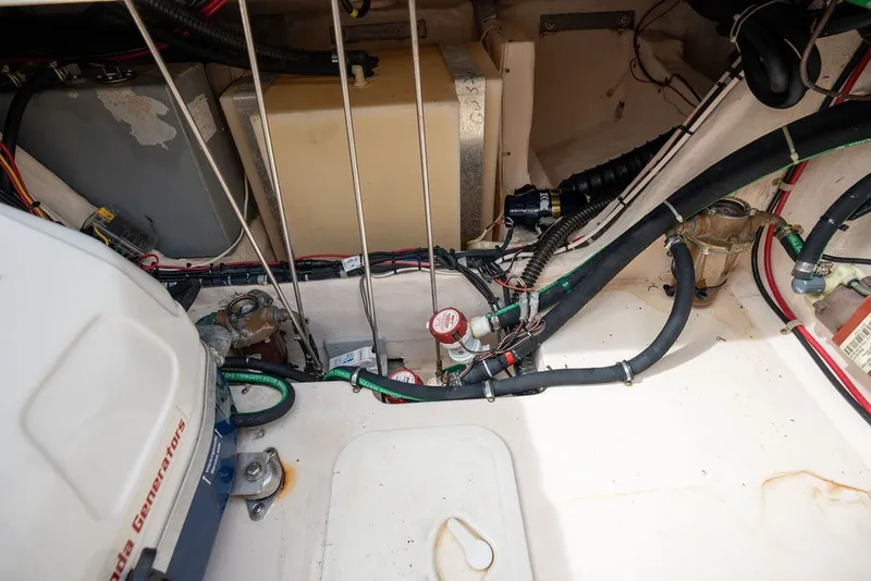 Slide: The Image of Engine compartment of a 2014 Grady-White Canyon 376 boat, showing wiring and components. - 51