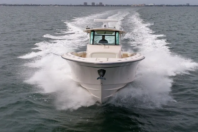 Slide: The Image of 2014 Grady-White Canyon 376 boat cruising swiftly on open water. - 11