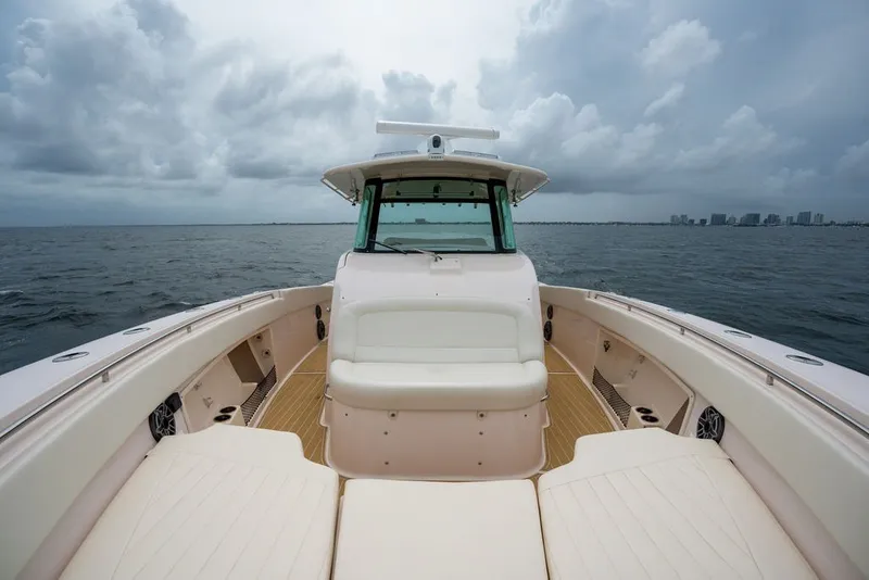 Slide: The Image of 2014 Grady-White Canyon 376 boat on open water under cloudy skies. - 19