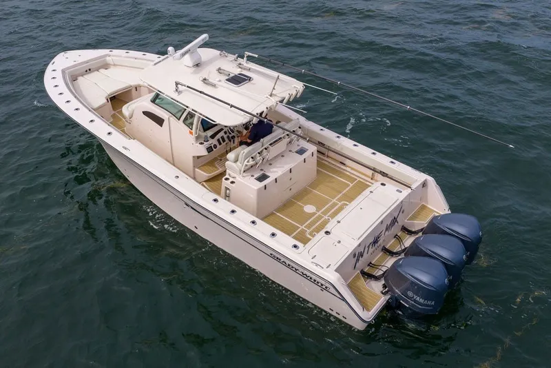 Slide: The Image of 2014 Grady-White Canyon 376 boat on water, featuring triple Yamaha engines. - 8