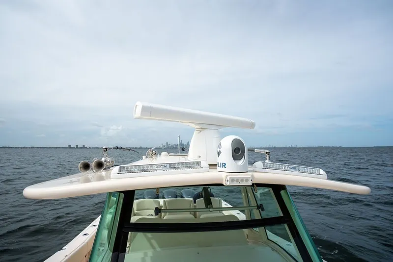 Slide: The Image of 2014 Grady-White Canyon 376 boat on open water, featuring advanced navigation equipment. - 55