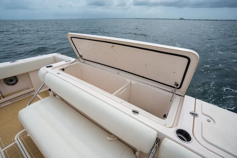 Slide: The Image of 2014 Grady-White Canyon 376 boat with open storage compartment on the ocean. - 26