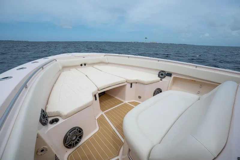 Slide: The Image of 2014 Grady-White Canyon 376 boat interior with cushioned seating and ocean view. - 18