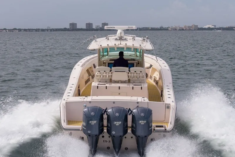 Slide: The Image of 2014 Grady-White Canyon 376 boat cruising on open water, rear view. - 13