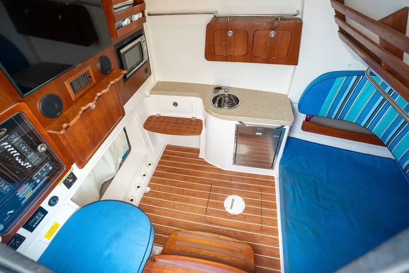 Slide: The Image of Interior of 2014 Grady-White Canyon 376 boat with kitchenette and seating area. - 56