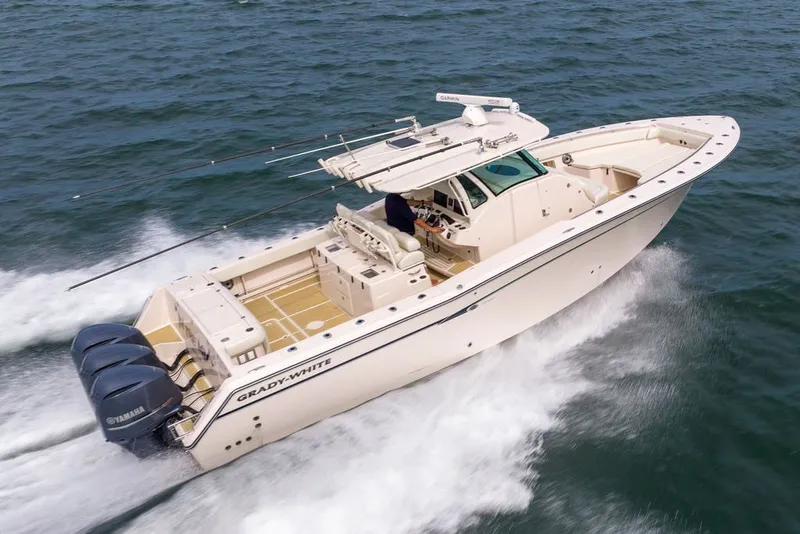 The Image of 2014 Grady-White Canyon 376 boat cruising on open water with triple Yamaha engines. - 0