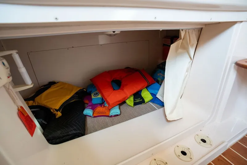 Slide: The Image of Storage area with life jackets in a 2014 Grady-White Canyon 376 boat. - 65