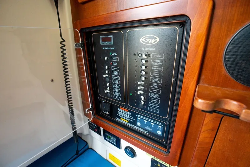 Slide: The Image of Control panel of a 2014 Grady-White Canyon 376 boat, featuring various switches and indicators. - 59