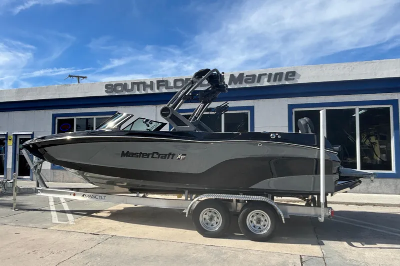 The Image of 2026 MasterCraft XT24 boat on trailer at South Florida Marine dealership. - 0