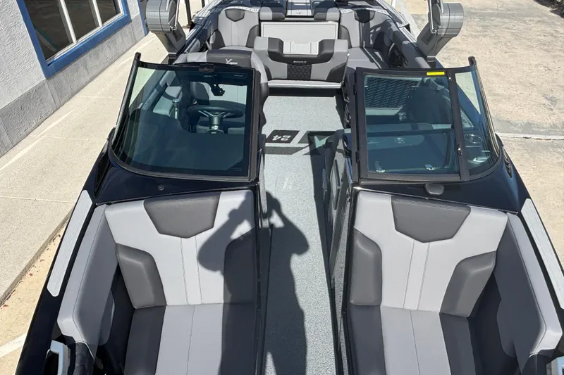 Slide: The Image of 2026 MasterCraft XT24 boat interior with sleek gray seating and modern design. - 11