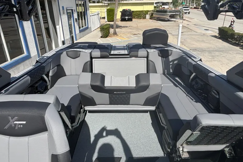 Slide: The Image of 2026 MasterCraft XT24 boat interior with gray seating and modern design. - 12