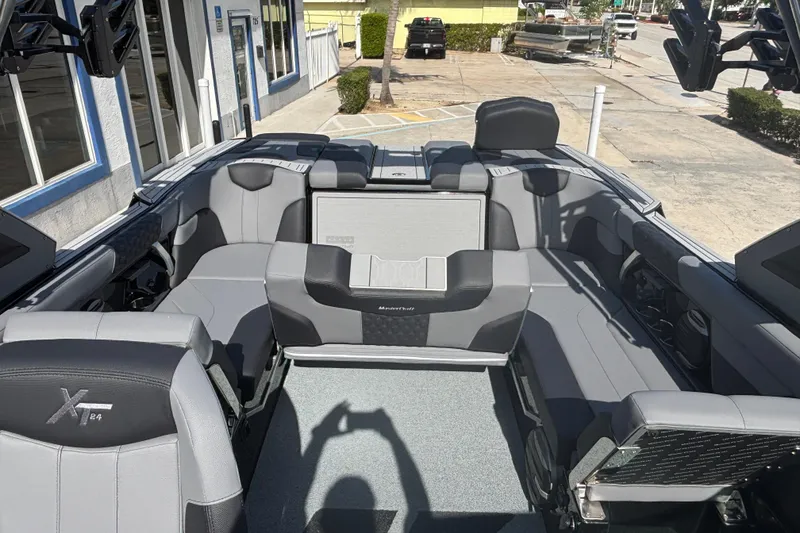Slide: The Image of 2026 MasterCraft XT24 boat interior with gray seating and modern design. - 13