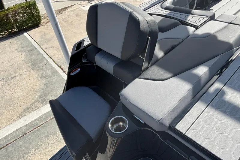 Slide: The Image of 2026 MasterCraft XT24 boat interior with sleek seating and cup holder. - 3
