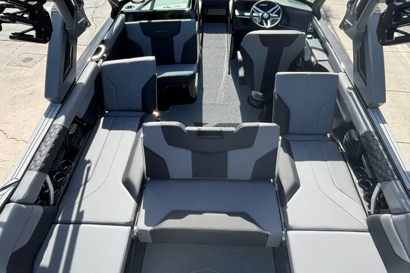 Slide: The Image of 2026 MasterCraft XT24 boat interior with modern seating and steering wheel. - 9