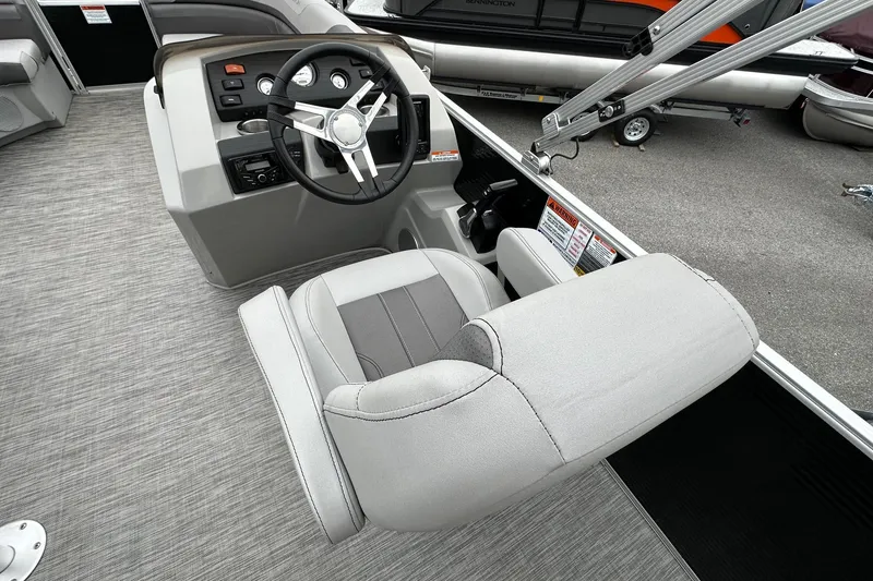 Slide: The Image of 2020 Bennington 20 SSNPX pontoon boat interior with steering console and seating. - 11