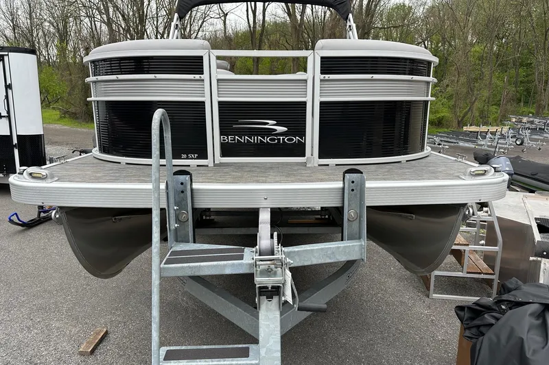 Slide: The Image of 2020 Bennington 20 SSNPX pontoon boat with VMAX 90 SHO engine, parked on trailer. - 2