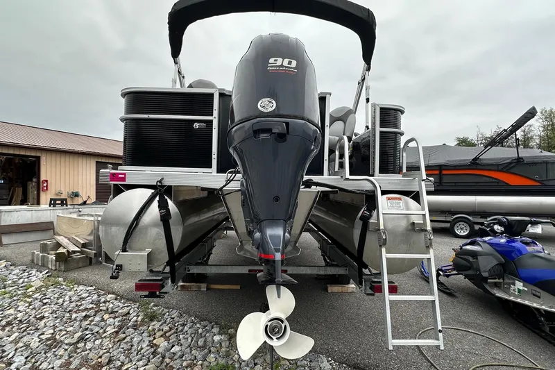 Slide: The Image of 2020 Bennington 20 SSNPX pontoon boat with VMAX 90 SHO engine, parked outdoors. - 5
