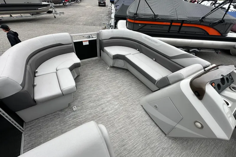 Slide: The Image of 2020 Bennington 20 SSNPX pontoon boat interior with gray seating and helm. - 8