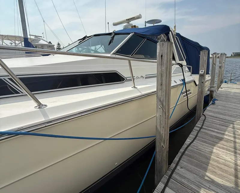 Slide: The Image of 1989 Sea Ray 460 Express Cruiser docked at marina, side view. - 9