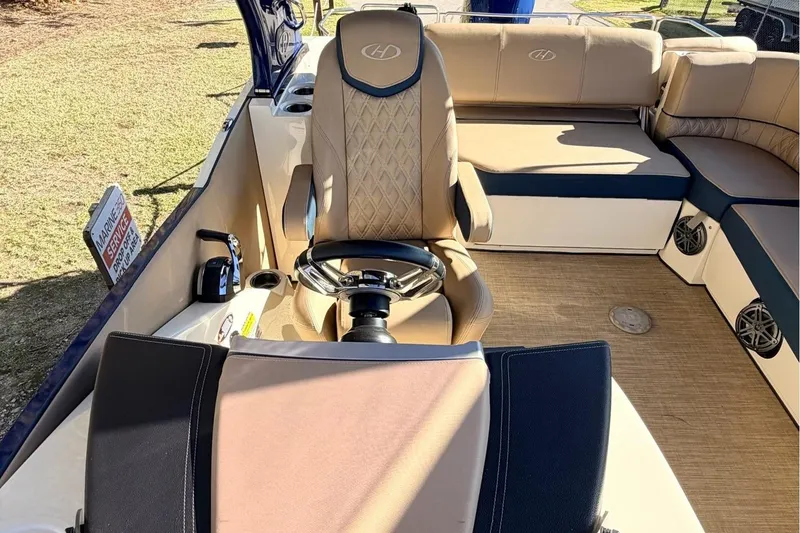 Slide: The Image of 2021 Harris Crowne SL 250 boat interior with luxurious seating and steering console. - 11