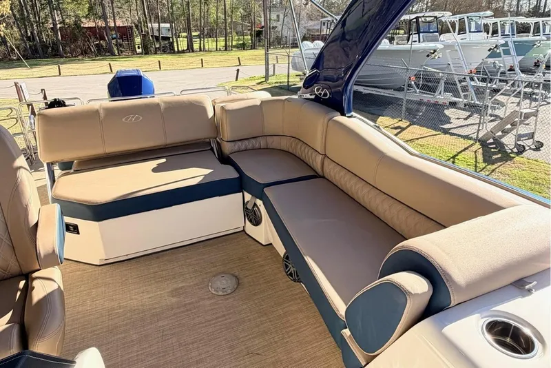 Slide: The Image of 2021 Harris Crowne SL 250 pontoon boat interior with beige seating and canopy. - 12