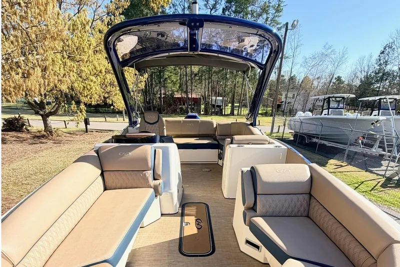 Slide: The Image of 2021 Harris Crowne SL 250 pontoon boat with spacious seating and elegant design. - 2