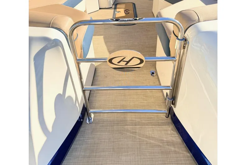 Slide: The Image of 2021 Harris Crowne SL 250 boat interior with luxurious seating and metal railing. - 6