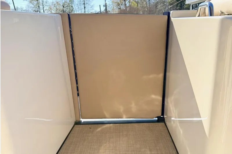 Slide: The Image of Interior view of 2021 Harris Crowne SL 250 boat with beige flooring and walls. - 8